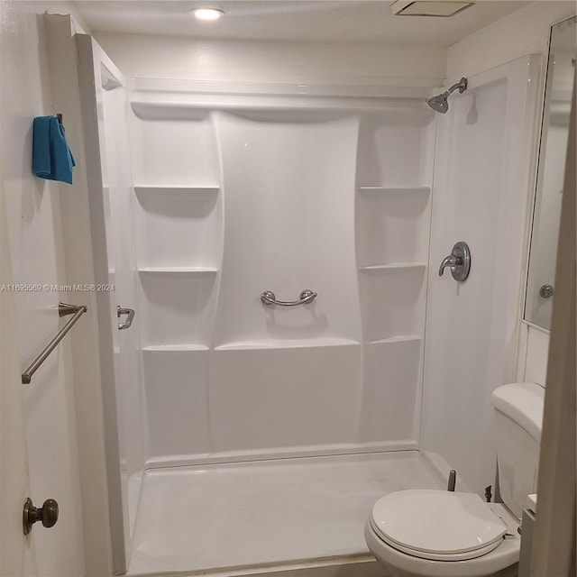 bathroom with toilet and walk in shower