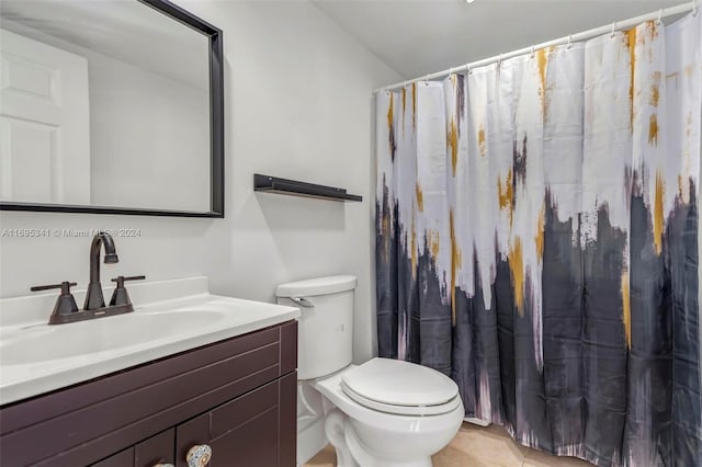 bathroom featuring tile patterned flooring, vanity, and toilet