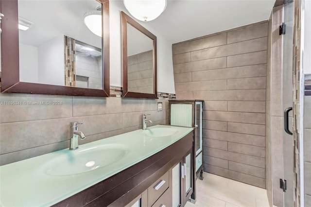 bathroom featuring tile patterned floors, vanity, and tile walls