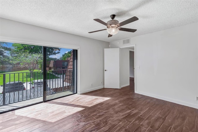 spare room featuring hardwood / wood-style flooring, ceiling fan, and a textured ceiling