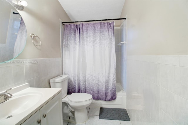 full bathroom featuring shower / bath combo, tile patterned flooring, toilet, vanity, and tile walls