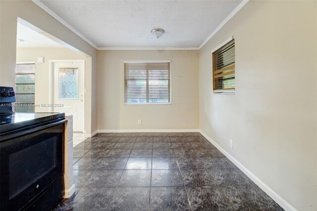 unfurnished dining area with a textured ceiling and crown molding