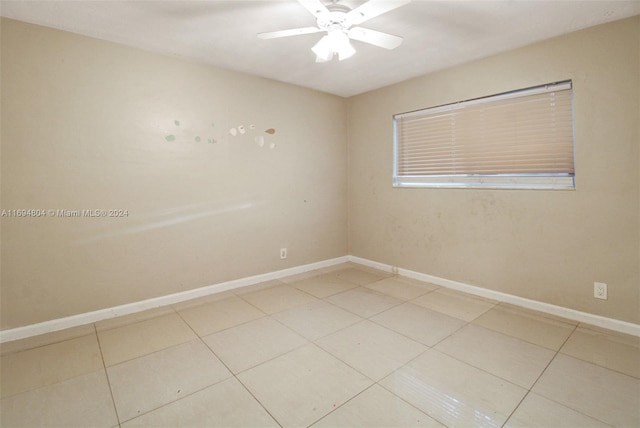 empty room featuring tile patterned flooring and ceiling fan