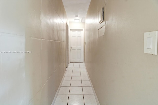 hall with light tile patterned floors