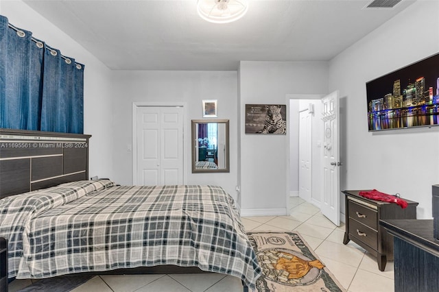 bedroom featuring a closet and light tile patterned flooring