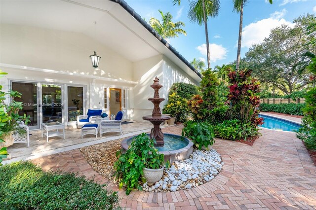 view of patio / terrace with a fenced in pool