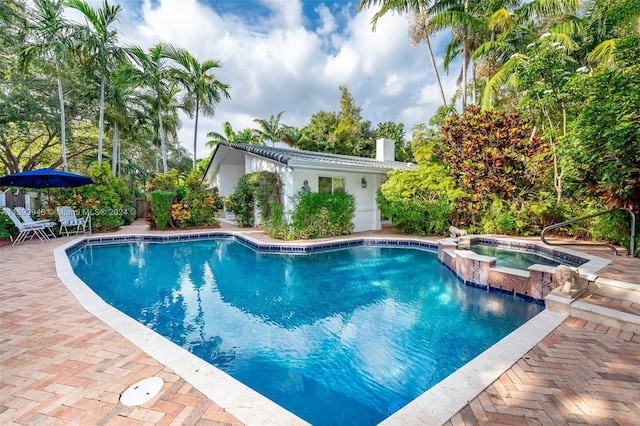 view of pool with an in ground hot tub and a patio