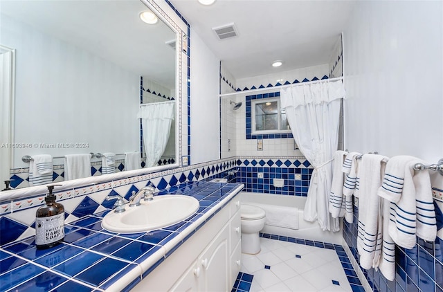 full bathroom featuring tile patterned floors, vanity, shower / tub combo, and toilet