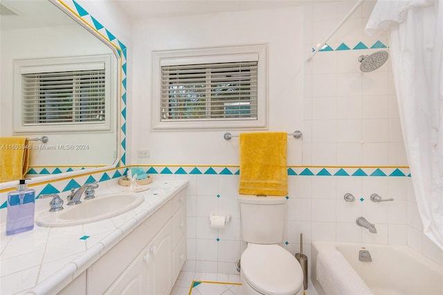 full bathroom featuring shower / bath combination with curtain, vanity, tile walls, tile patterned flooring, and toilet