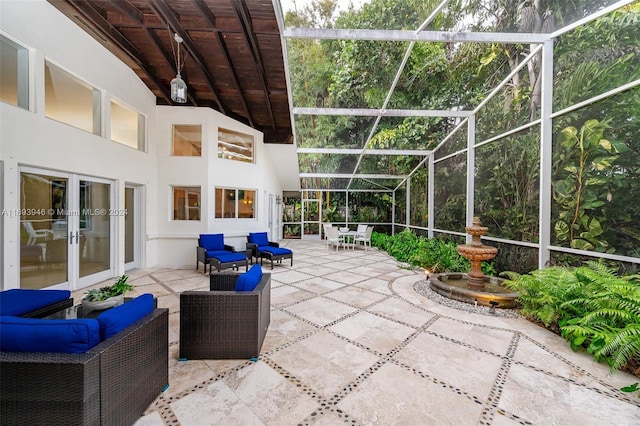 view of patio / terrace featuring glass enclosure, an outdoor living space, and french doors