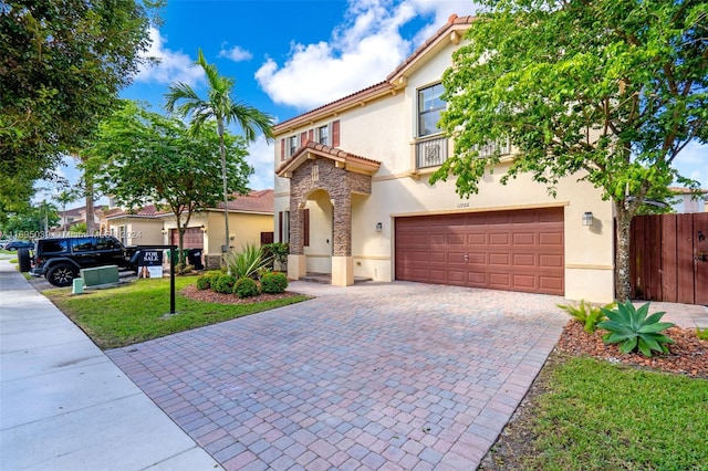 mediterranean / spanish-style house featuring a front lawn and a garage