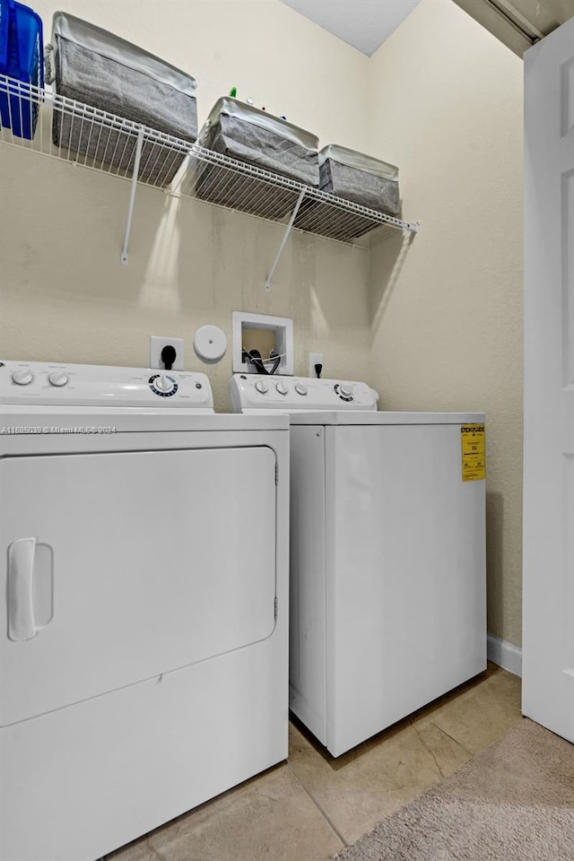 clothes washing area with washing machine and clothes dryer