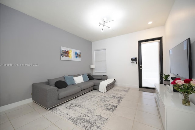 living room featuring light tile patterned floors and a chandelier