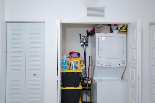 washroom featuring stacked washer and clothes dryer