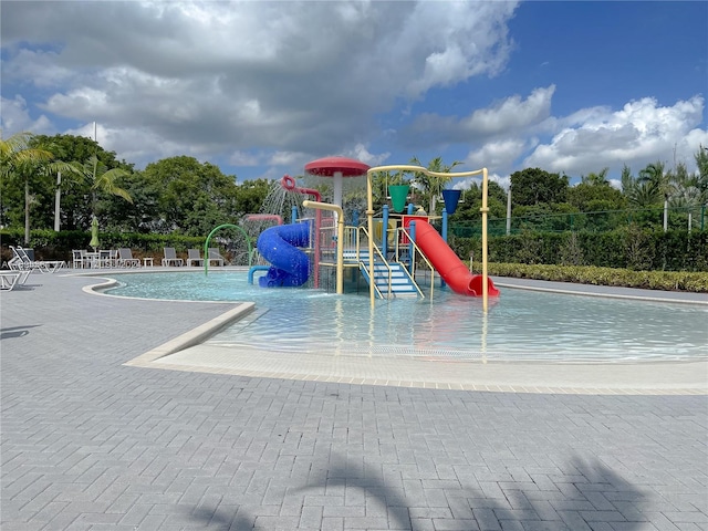 view of jungle gym with a community pool