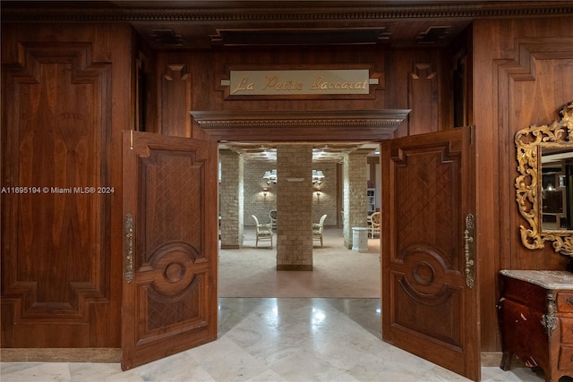 entrance foyer featuring wood walls