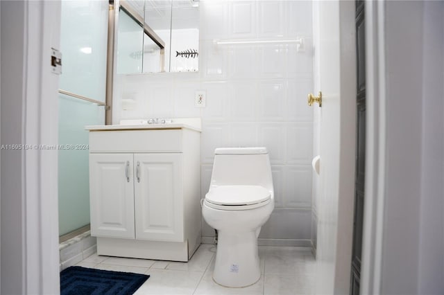 bathroom with vanity, an enclosed shower, tile patterned flooring, and toilet