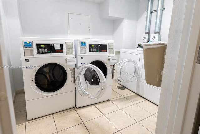 washroom featuring light tile patterned floors and washing machine and dryer