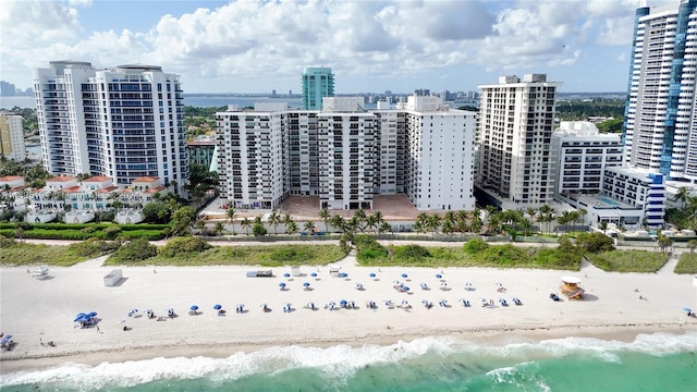 aerial view featuring a water view and a beach view