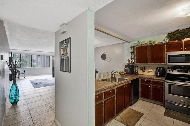 kitchen with a textured ceiling, light tile patterned flooring, sink, and appliances with stainless steel finishes