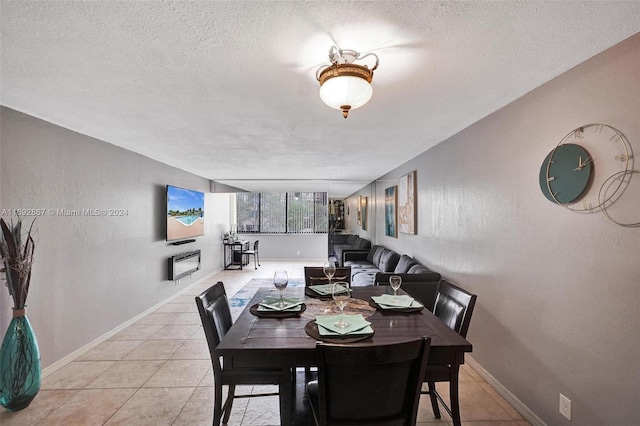 tiled dining area with a textured ceiling