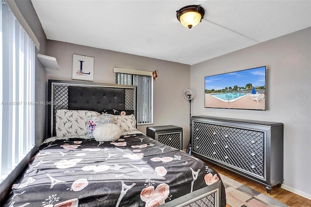 bedroom with hardwood / wood-style floors