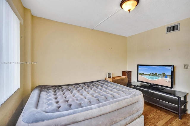 bedroom with hardwood / wood-style flooring