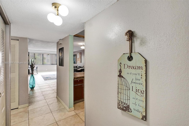 8010 Hampton Blvd Unit 211, North Lauderdale, FL 33068 - corridor with light tile patterned floors, a textured ceiling, and a textured wall
