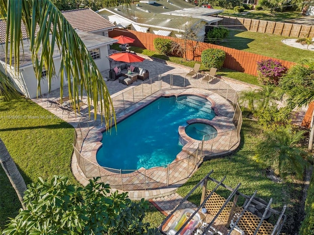 view of swimming pool featuring a patio area, an in ground hot tub, and a yard