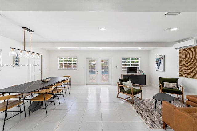 tiled living room featuring a wall unit AC and a healthy amount of sunlight