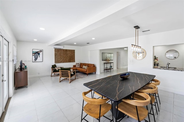 dining space featuring an AC wall unit, beamed ceiling, light tile patterned floors, and a notable chandelier