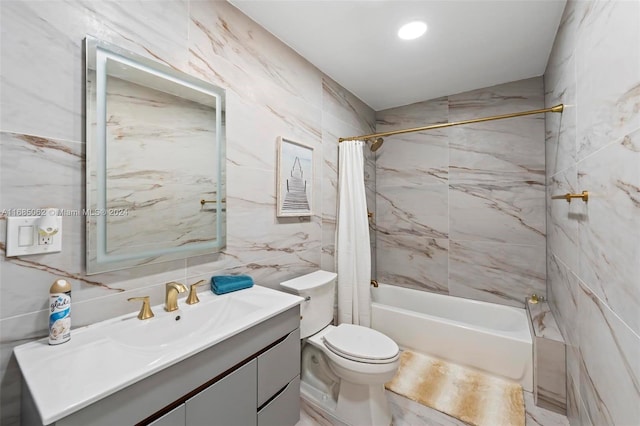 full bathroom with vanity, tile walls, and shower / tub combo