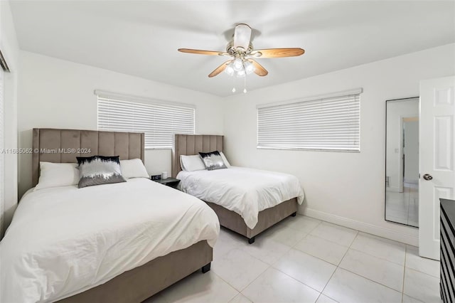 tiled bedroom featuring ceiling fan