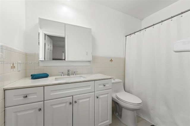 bathroom with vanity, tile walls, and toilet