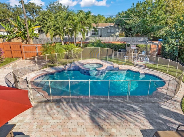 view of swimming pool with an in ground hot tub