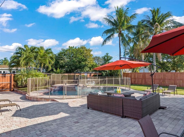 view of patio with outdoor lounge area, a fenced in pool, and pool water feature