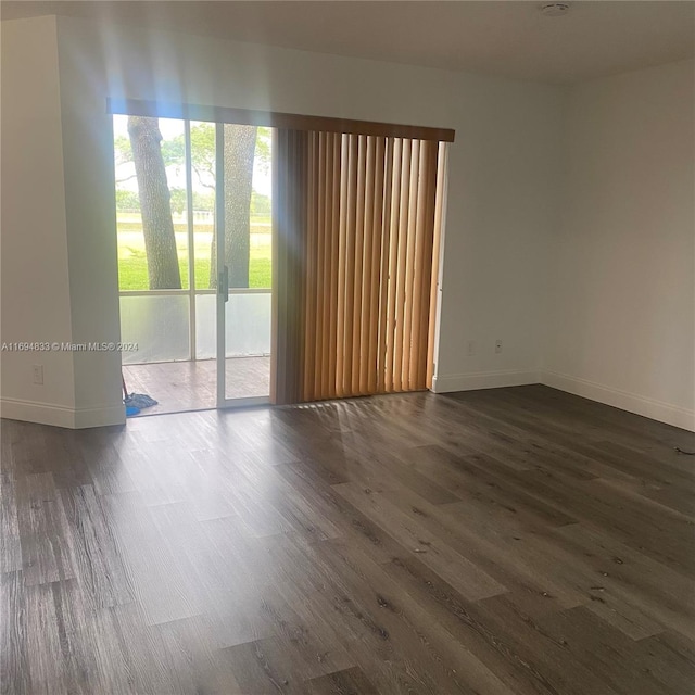 spare room featuring dark hardwood / wood-style floors