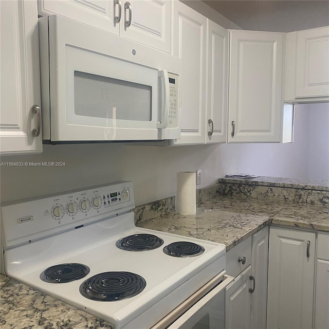 kitchen with white cabinets and white appliances