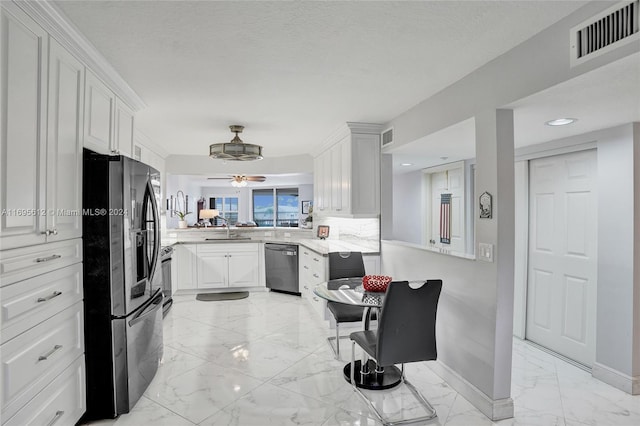 kitchen featuring white cabinetry, kitchen peninsula, sink, and appliances with stainless steel finishes