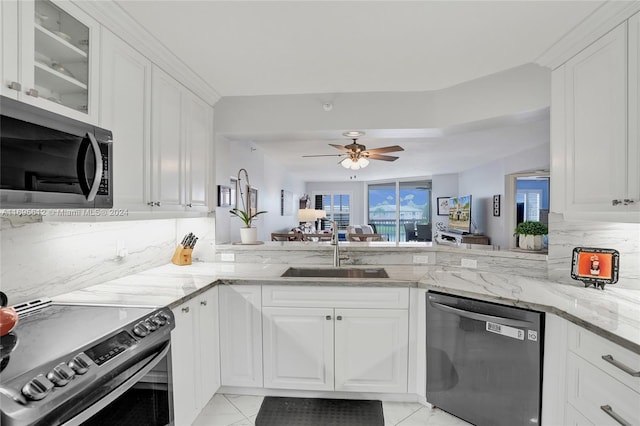 kitchen with white cabinetry, sink, appliances with stainless steel finishes, and tasteful backsplash