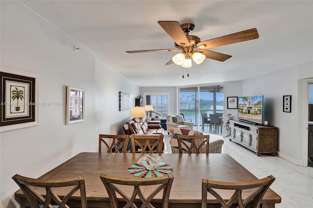 dining space featuring a textured ceiling and ceiling fan