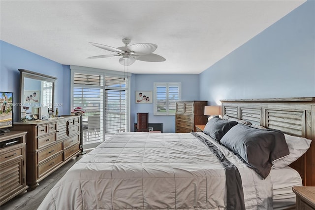 bedroom with dark hardwood / wood-style floors and ceiling fan