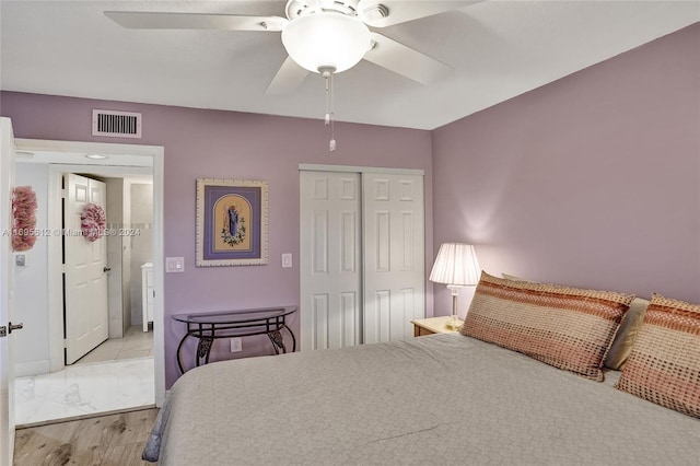 bedroom with a closet, ceiling fan, and light hardwood / wood-style flooring