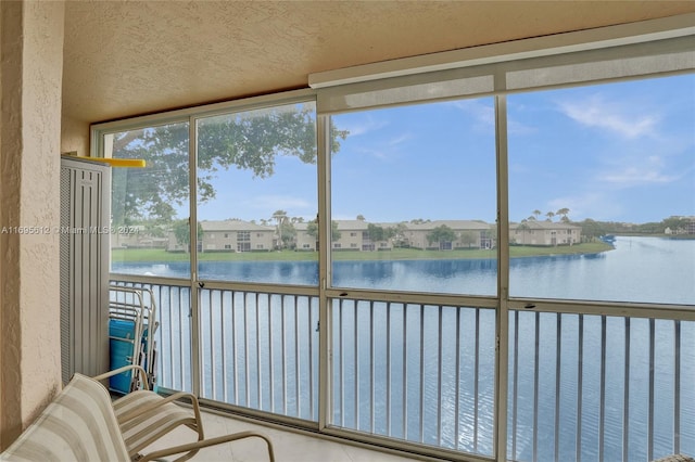 unfurnished sunroom with a water view