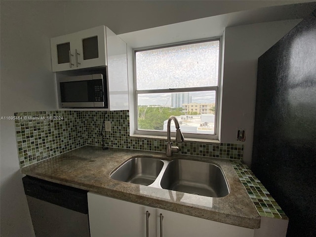 kitchen featuring a healthy amount of sunlight, white cabinetry, sink, and stainless steel appliances