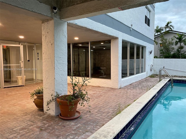 view of swimming pool with a patio