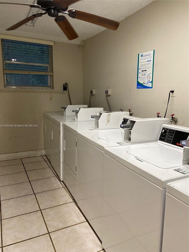 washroom with light tile patterned floors, a textured ceiling, and independent washer and dryer