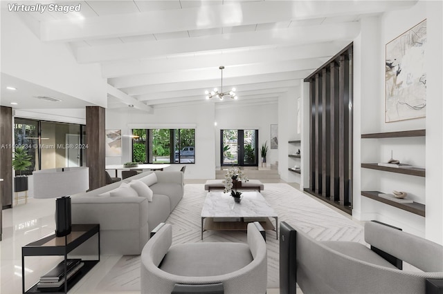 living room featuring lofted ceiling with beams and a chandelier