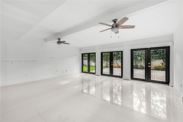 tiled empty room with vaulted ceiling with beams, plenty of natural light, ceiling fan, and french doors