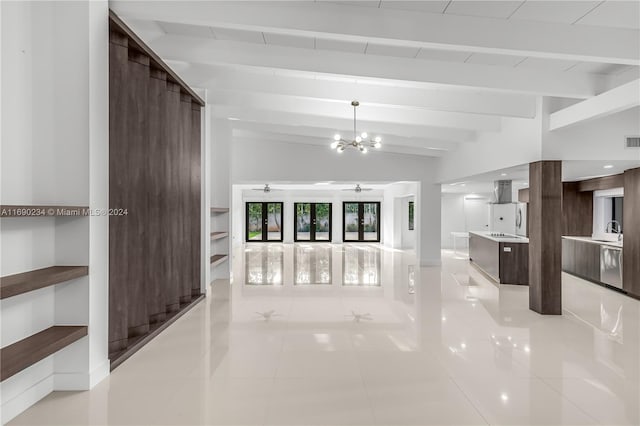 unfurnished living room featuring ceiling fan with notable chandelier, lofted ceiling with beams, and light tile patterned flooring